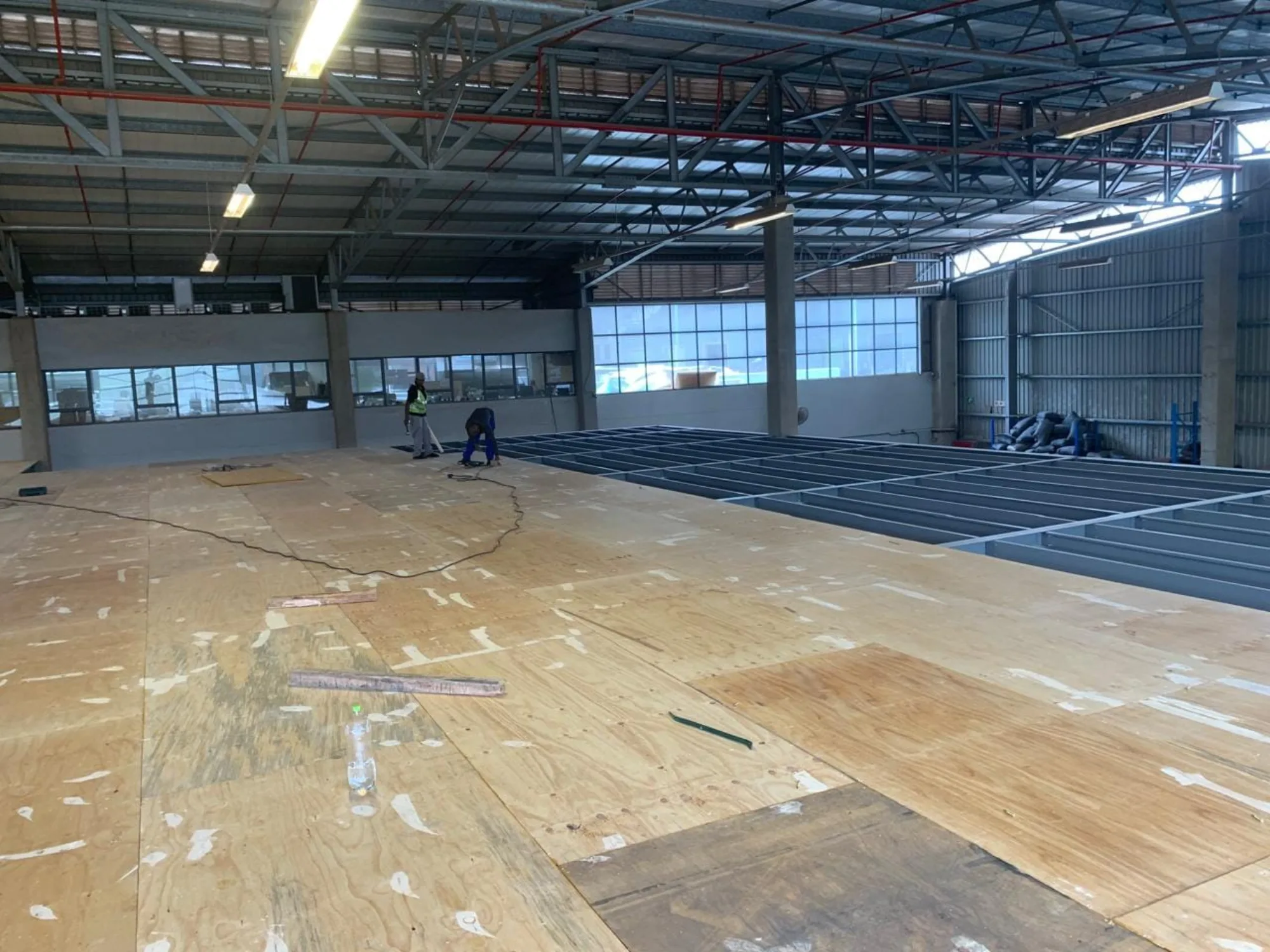 Structural timber decking being laid across the steel mezzanine frame