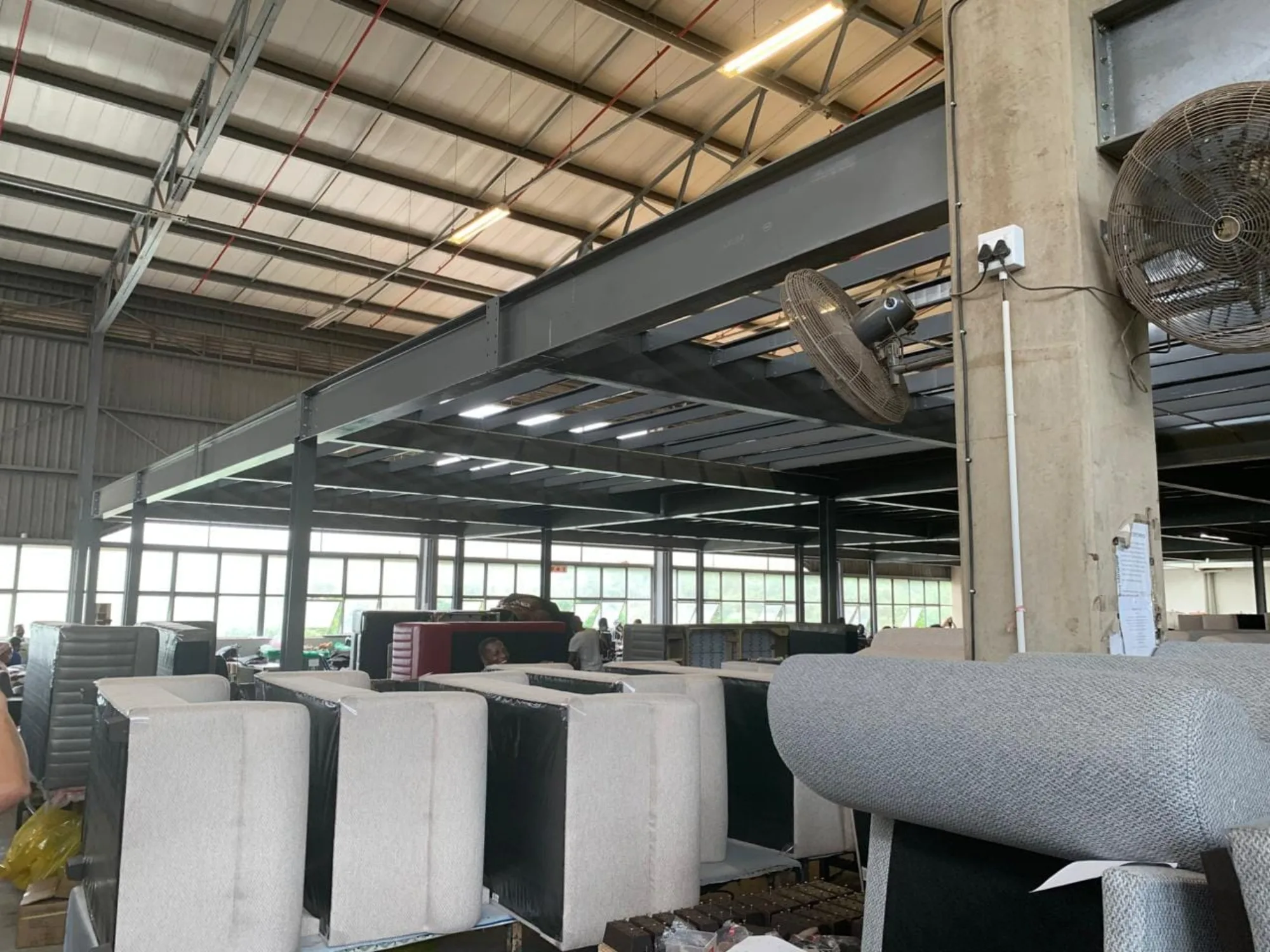 Underside of a steel mezzanine floor spanning a furniture factory