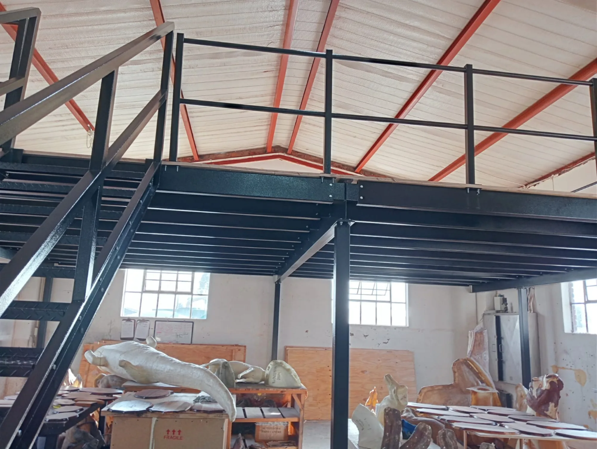 Black steel mezzanine floor and stair built above a taxidermy studio